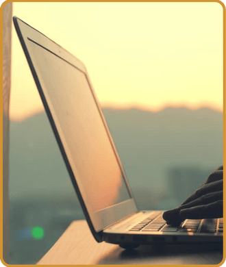 Image of copywriting and content creation on laptop with sunset and Colorado mountains in background