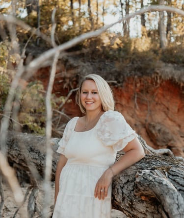 Picture of Emily by a fallen tree