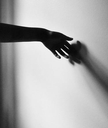 hand on wall casting shadow lvf.lvx black and white photography
