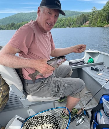 Client catching rainbow trout in lakes near Ottawa