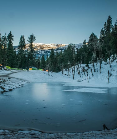 a lake with a lot of snow and tents