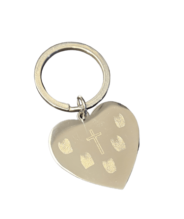 a heart shaped keychain with finger prints on it