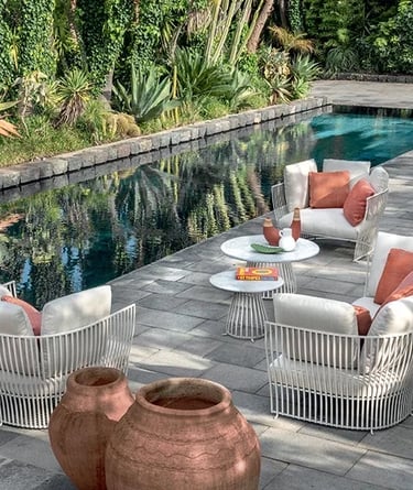 Outdoor seating area with weather-resistant furniture, natural stone, woven textures and performance