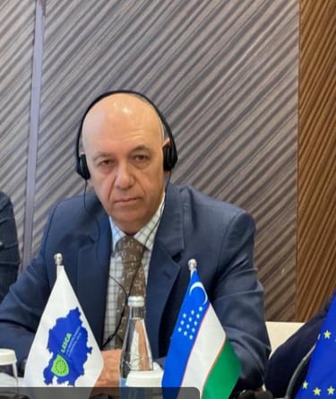 a man in a suit and headphones sitting at a table