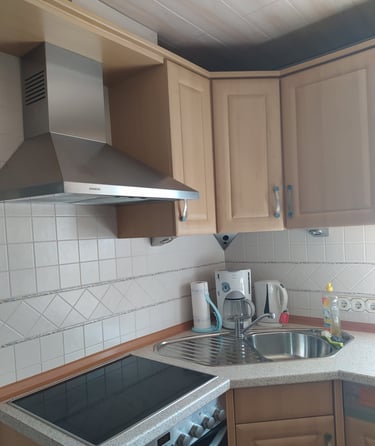 a kitchen with a stove top and a stove top