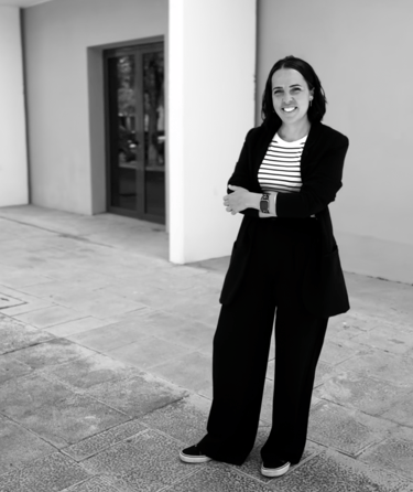 a woman in a suit and striped shirt