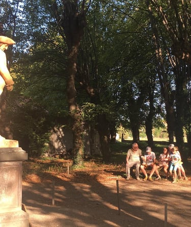 a group of people sitting on a bench in a park
