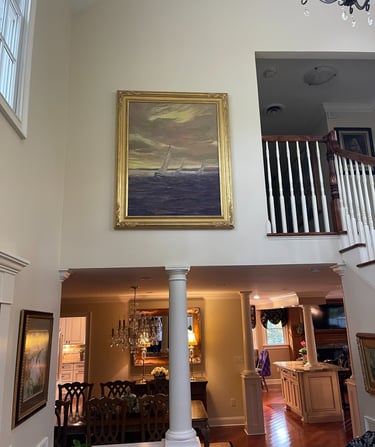 large oil painting hanging on a wall in client's home