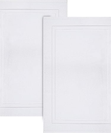 Set of two white plush cotton bath mats with a decorative rectangular border for bathroom floor decor.