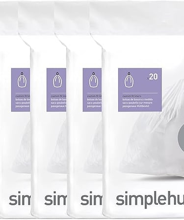 a person holding a bag of trash bags