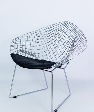 Metal wire designer chair with black cushion seat