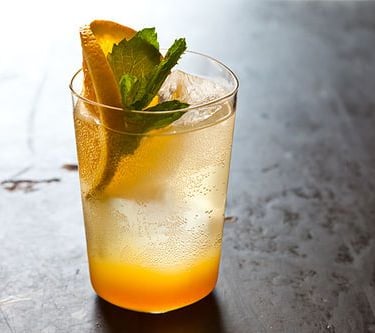 A vibrant,, and refreshing mocktail combining sweet orange juice