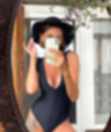 a sugar baby in a swimsuit is taking a selfie