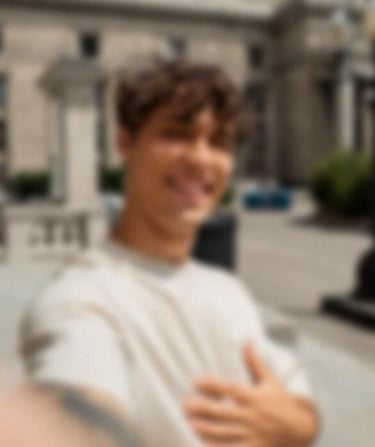 a sugar daddy in a white shirt is holding a cell phone