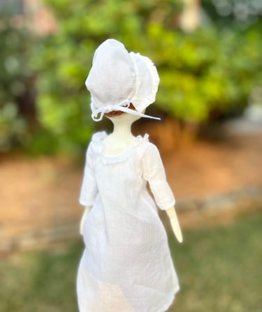 a doll doll with a white dress and a white dress