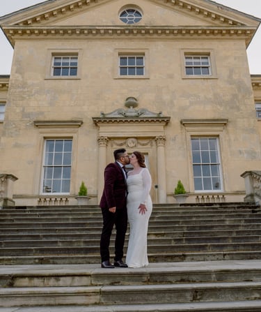 Couple kissing in front of a registry