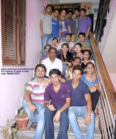 a group of people sitting on stairs with a man in a purple shirt