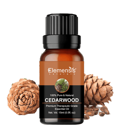 Cedarwoord essential oil bottle next to pinecones