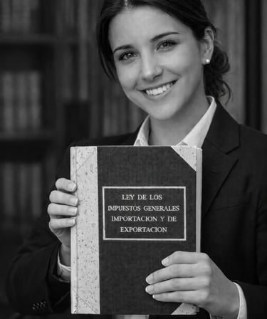 Smiling female lawyer holding a book on general import and export tax laws in a library.