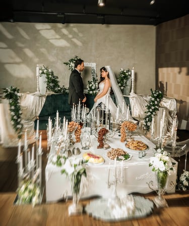 Bride and groom facing each other at Sofreh Aghd setup, captured by Fred Art Studio