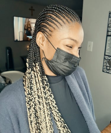 a woman with cornrows hairstyle