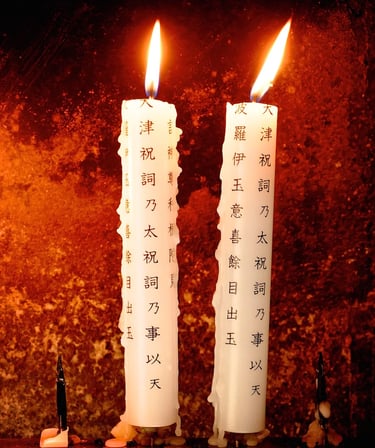 two candles with japanese writing on them