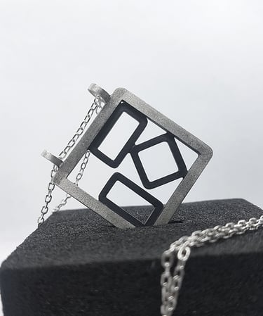 a square shaped pendant with a geometric design