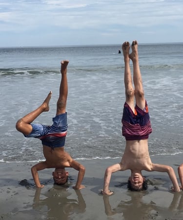 4 boys doing headstands on the beach in Rye, New Hamsphire