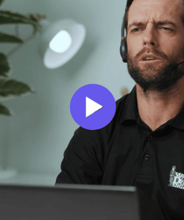 man with a headset working on a laptop