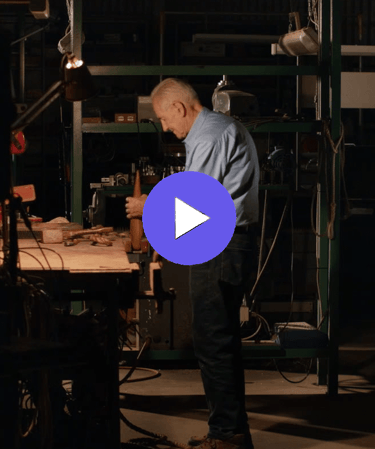 an man in a work shop with a blue shirt