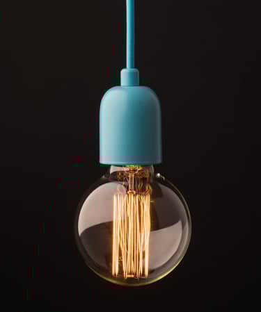 Product photography - a light bulb hanging on a black background