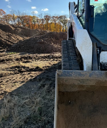 skid-steer-with-dirt-pile