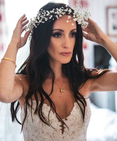 A bride in a wedding dress in full hair & makeup