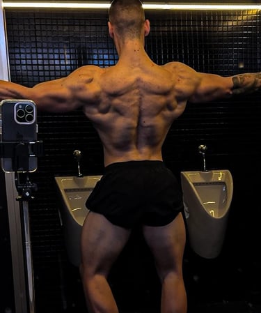 a man in a black underwear suit with a muscular body