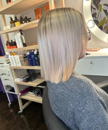 a woman with blonde hair and a grey haircut