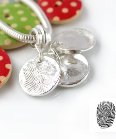 Three silver fingerprint charms. Your family's real fingerprints