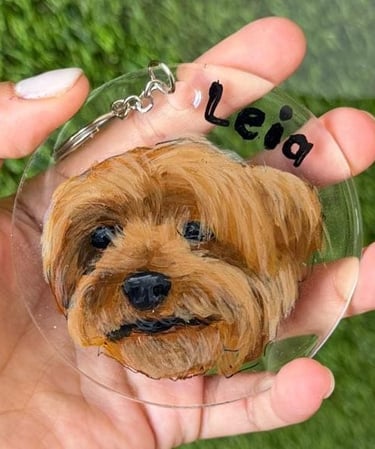 Un llavero personalizado de acrílico transparente con el retrato pintado a mano de un perro terrier 
