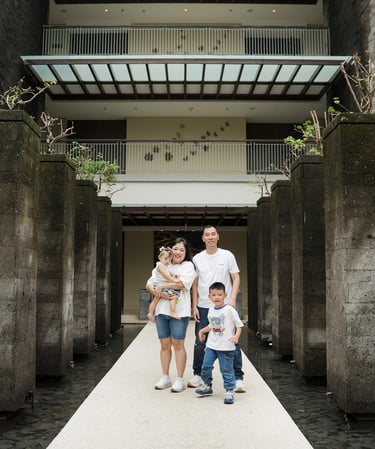 family walking through architectural walkway at Movenpick Jimbaran Bali during a lifestyle photography session