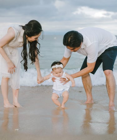 Family walking together in shallow water during Sofitel Nusa Dua Bali family photography session