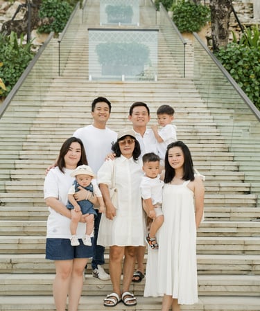 Extended family portrait on the grand staircase at The Apurva Kempinski Nusa Dua Bali