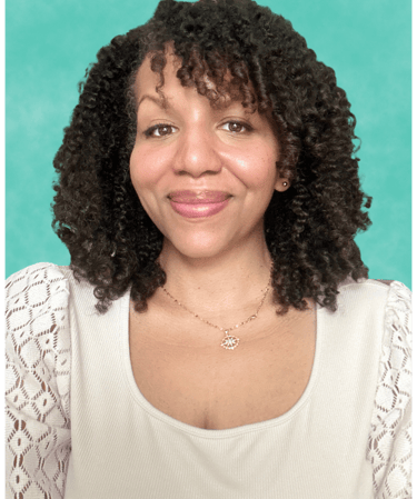 a woman with curly hair and a necklace