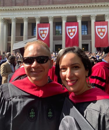 a man and woman in graduation gowns and caps