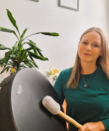Chrissy holding a drum and a mallet