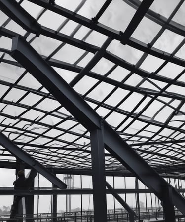 Steel piping framework being installed at an industrial site by skilled workers.