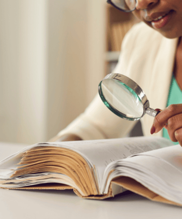 Legally blind child using assistive technology, screen reader, video magnifier for vision impairment