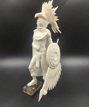 A 3D printed Aztec eagle warrior miniature statue with detailed headdress, shield, and spear.