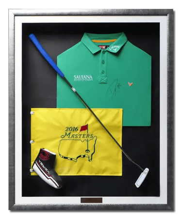 Golf memorabilia - club, flag and shirt framed in a dark silver shadow box frame