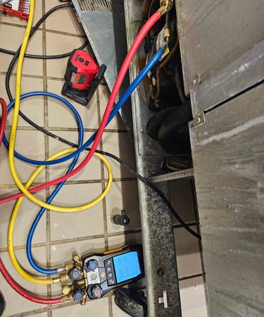 Appliance repair technician is replacing fridge compressor