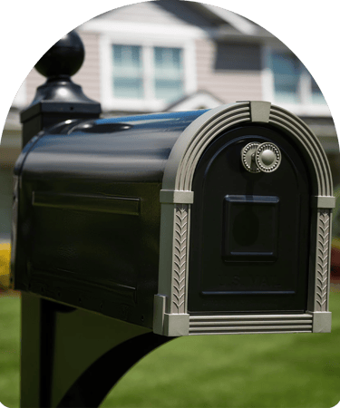 black and grey mailbox in front of a home