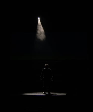 a man standing in front of a spotlight light